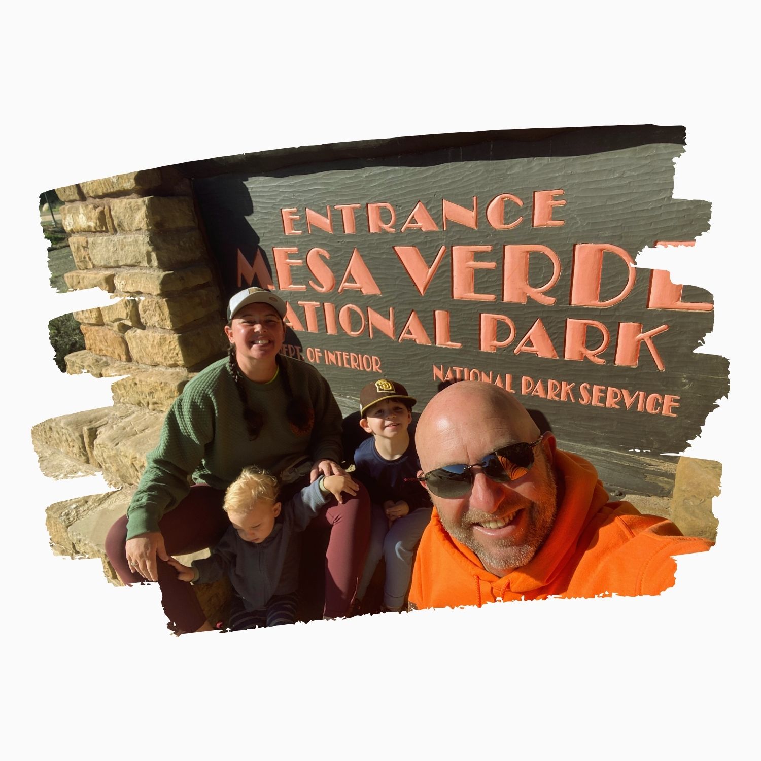 family in front of mesa verde sign