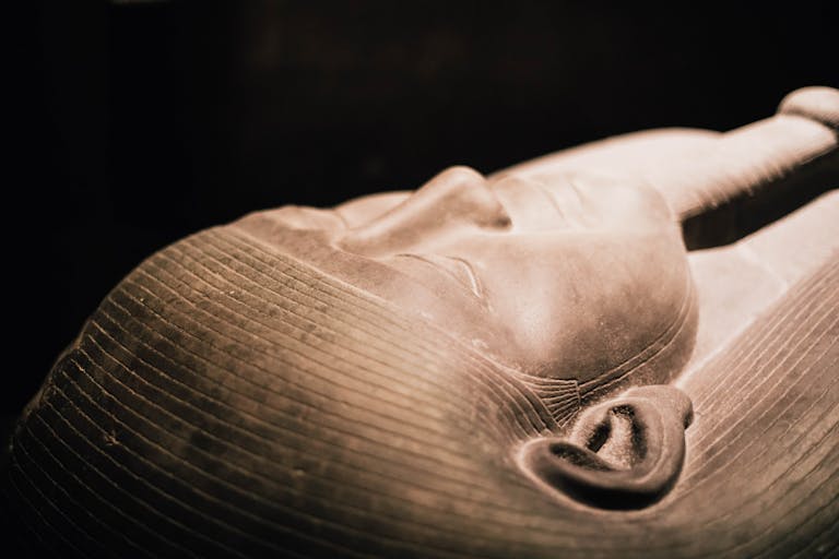 Detailed close-up of an ancient Egyptian sarcophagus, showcasing intricate craftsmanship.